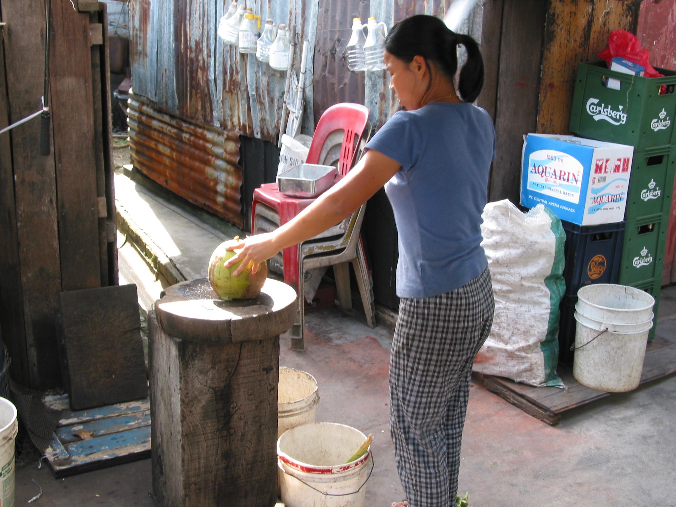 opening a coconut with a machete