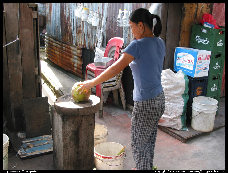 opening a coconut with a machete