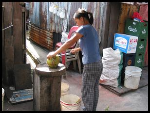 opening a coconut with a machete