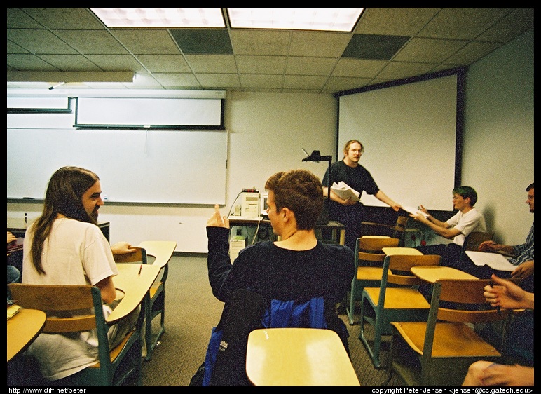 Thad handing out assignments in CS4600