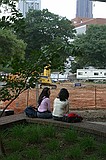 girls sitting in front of the construction