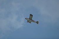 flying the Piper low and slow over the field ... dragging an advertisement for a tittie bar. notice the flaps down a notch