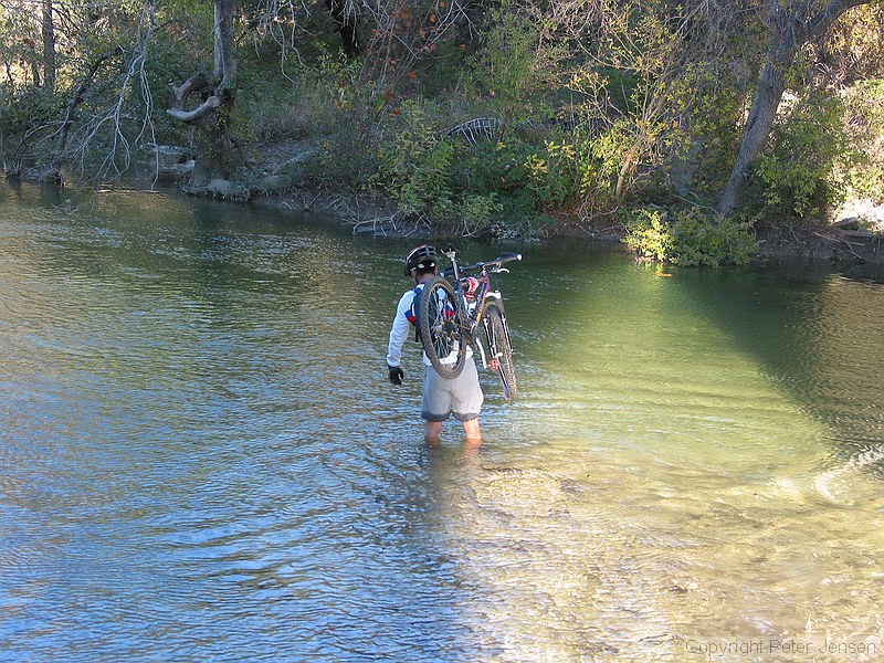 mountain biker crossing the stream