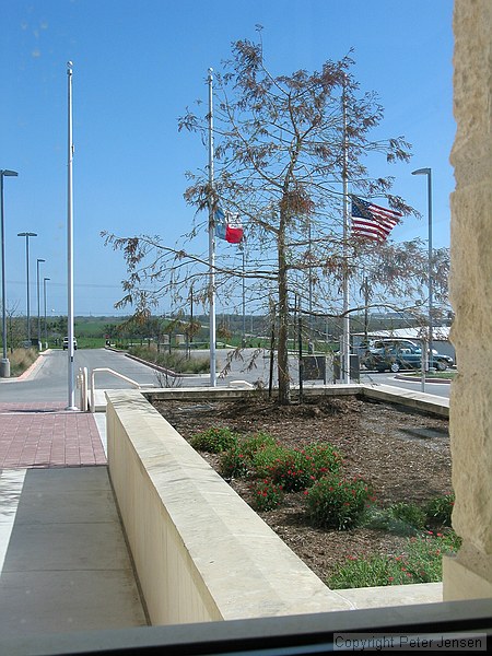 flags at half staff at the Pflugerville Justice Center