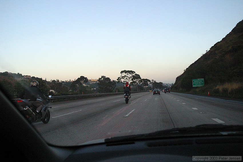 goofy motorcycle guys showing off by doing wheelies on San Diego