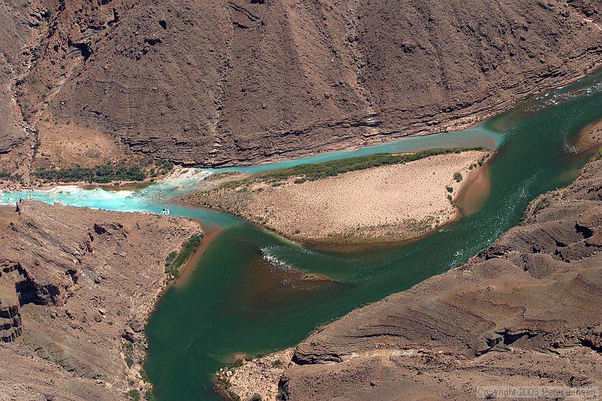 note the two rafts docked up against the shore in the left half of the image (light blue water area off of the main channel)