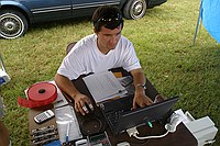 Oleg entering scores into the computer (powered by a deep cycle and 400 watt inverter)