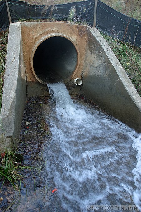 outflow level is pretty low at this point; don't know but suspect that the 4" pipe is for draining things below the level of the large culvert