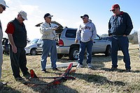 Tom, Buddy, George, Al, and AJ contemplating Al's restoration of the Hobie Hawk