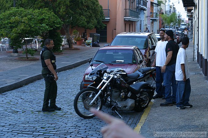 locals talking with a police officer about this bike