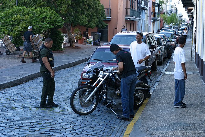 locals talking with a police officer about this bike