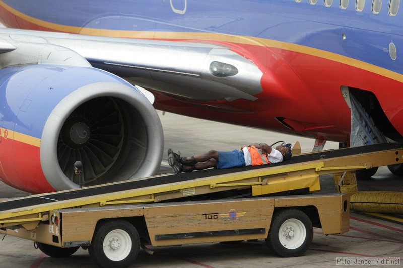 Southwest ramp worker taking a break while waiting for bags to arrive.