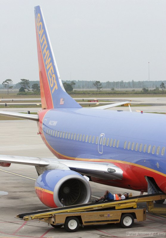 Southwest ramp worker taking a break while waiting for bags to arrive.