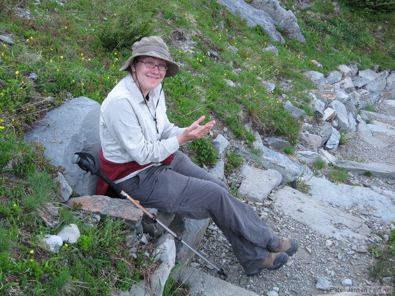 Laura pretending to read at the nice seat on the trail