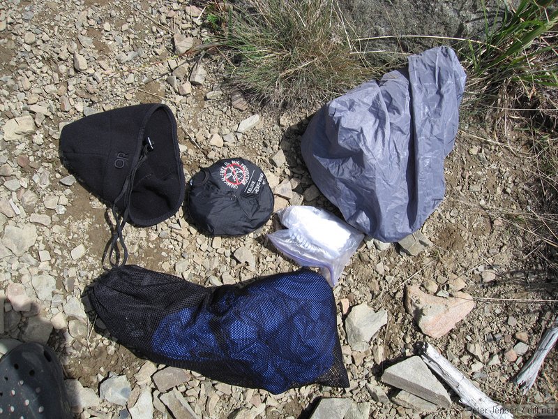 Outdoor Research warm hat, mosquito head-net (unused this trip), toilet paper and a small container of hand sanitizer, REI pack cover, and stuff sack containing a rain jacket and rain pants