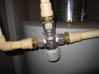 mixing valve that takes hot water heater output and mixes cold water for normal hot water service