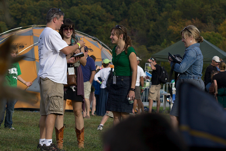 a fan getting an autograph from The Good Lovelies