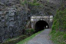 a cyclist who stopped to turn on very bright lights before heading in to the tunnel