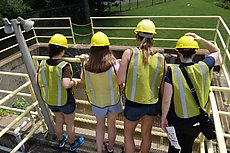 women observing sewage treatment plant output