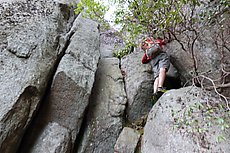 sketchy climb up through a gulley with a fixed rope