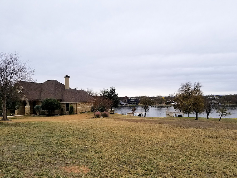 view of the house from across the lake/river