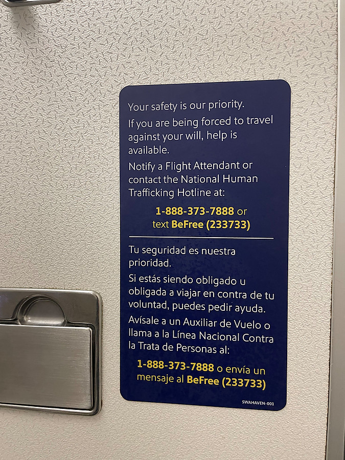 new human trafficking signage in airplane bathrooms